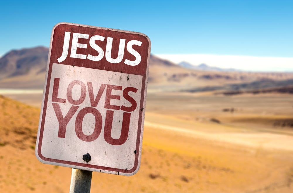 Jesus Loves You sign with a desert background